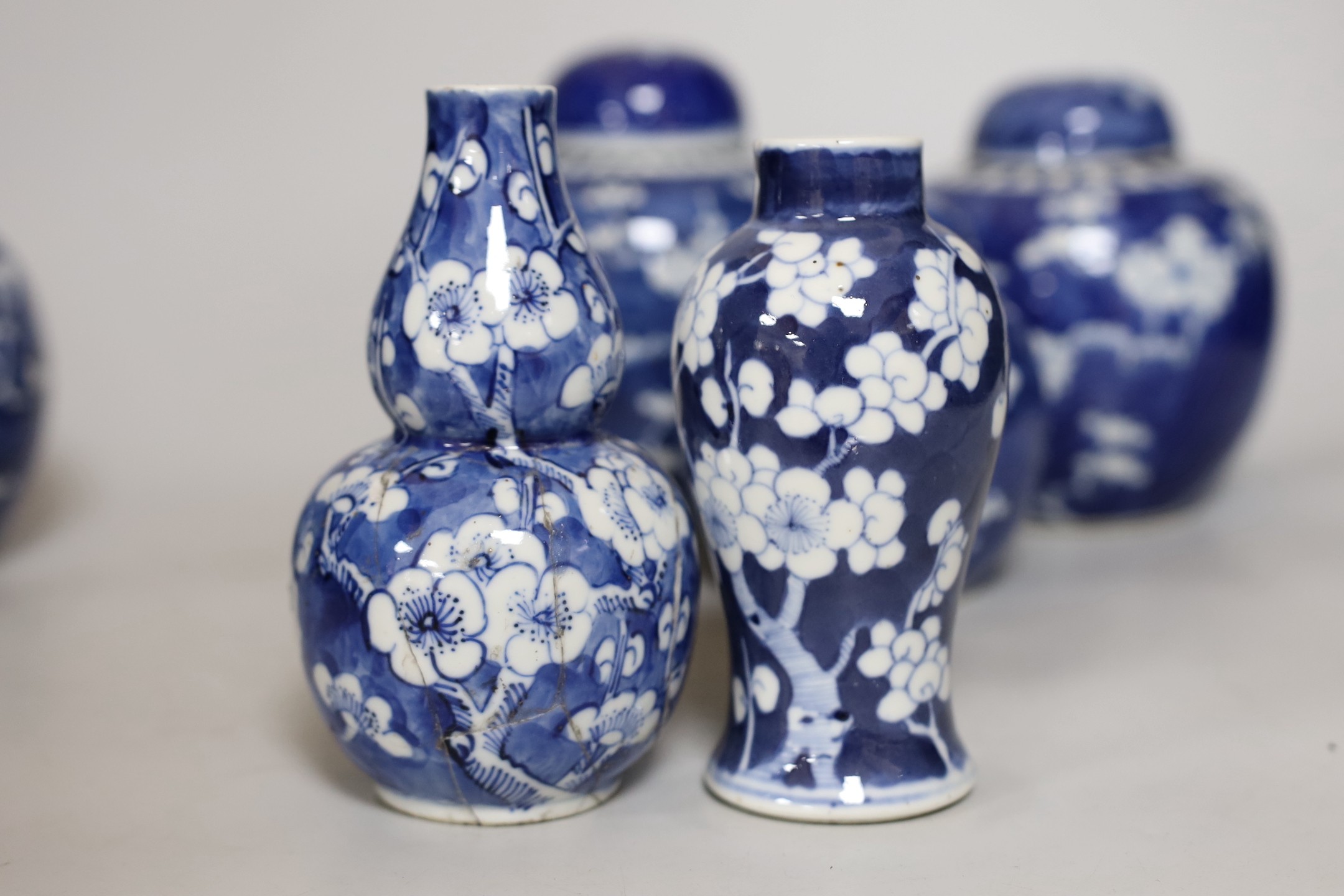 Four Chinese blue and white prunus pattern ginger jars, together with three similar vases. 19th/early 20th century, Tallest 15cm